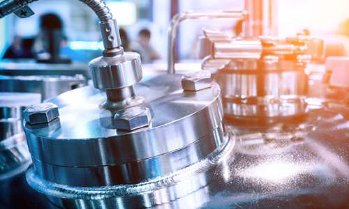 Close-up of a shiny stainless steel industrial machine component.